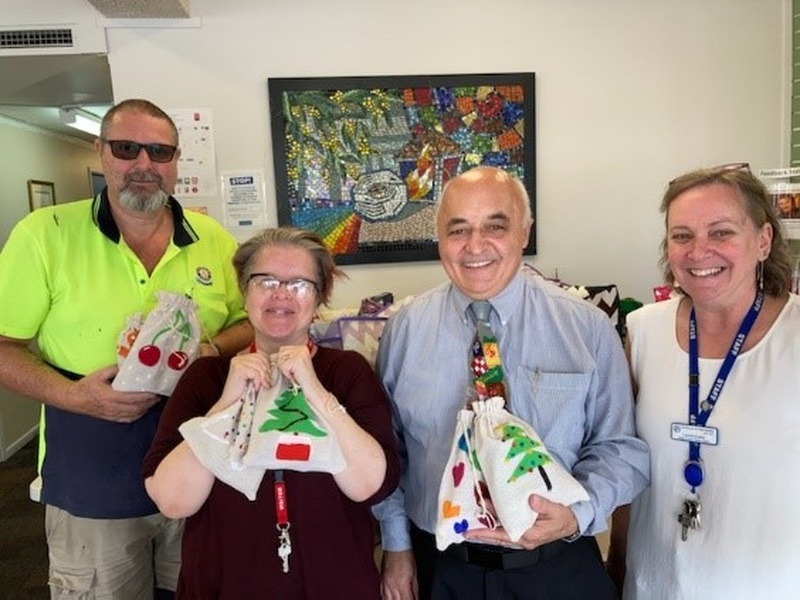 Nagle Centre staff gratefully receive the decorated toiletry bags.